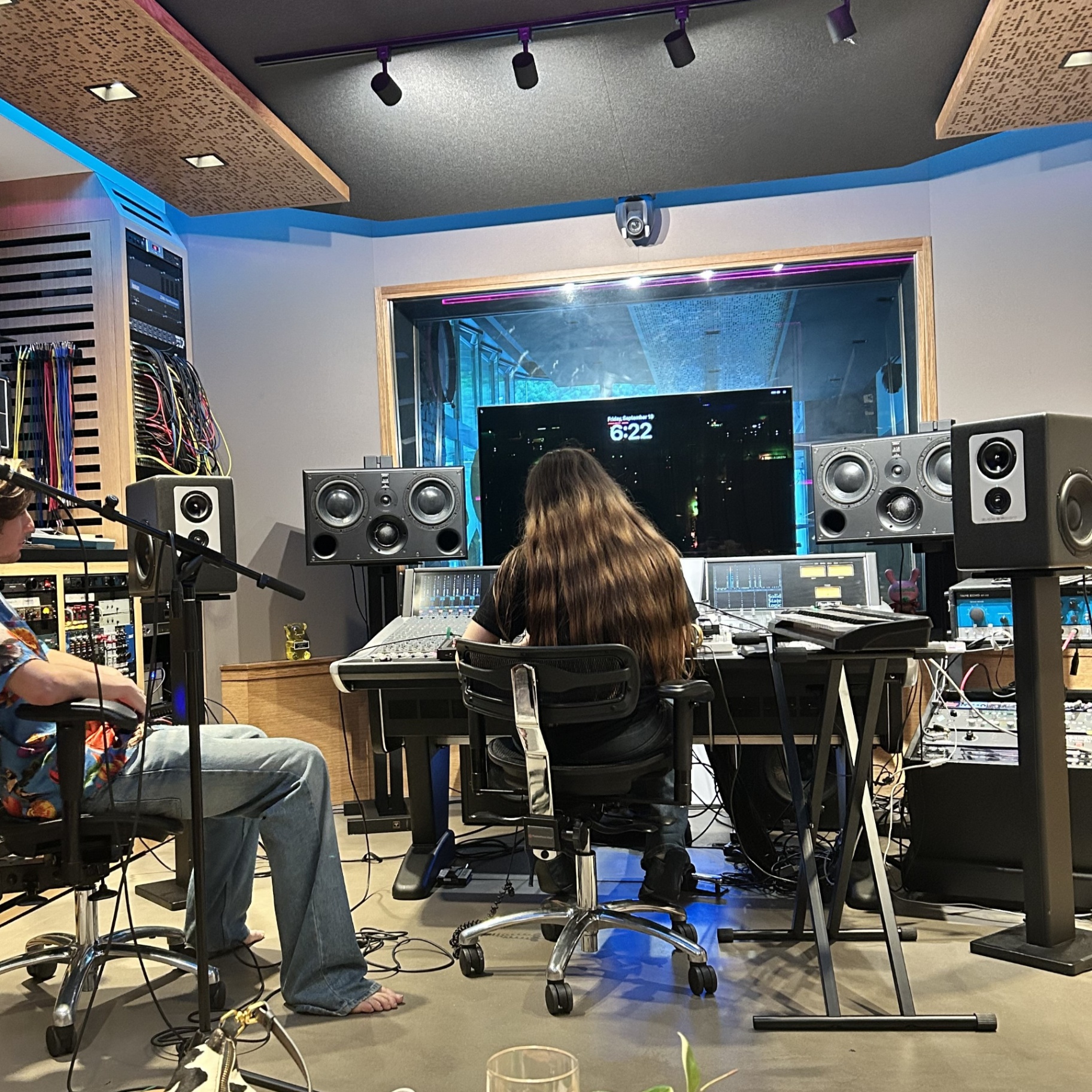 Recording studio control room with mixing console and monitors